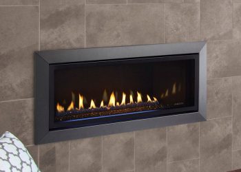 Modern gas fireplace embedded in a sleek wall with gray tiles, featuring vibrant flames for a cozy ambiance.
