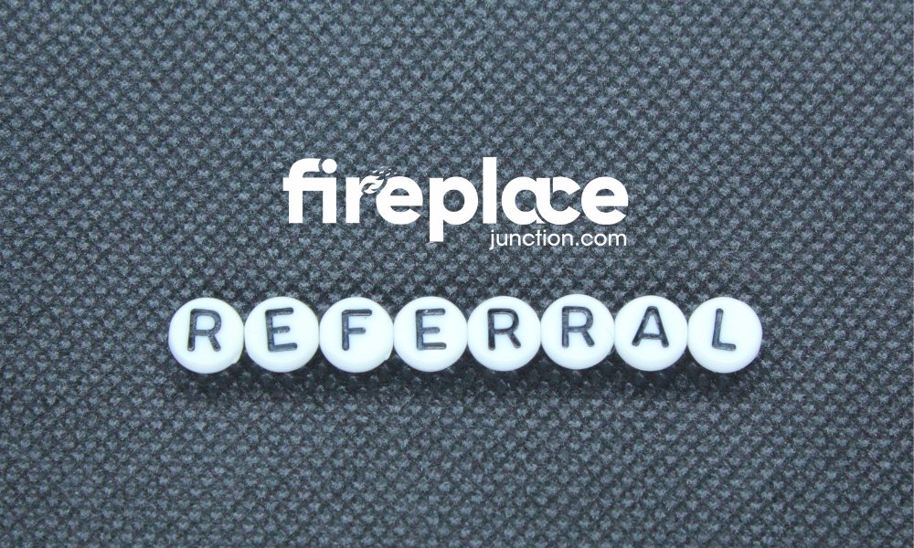 White beads spelling "REFERRAL" on a textured gray background with the word "fireplace" and "junction.com" prominently displayed.