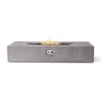 Modern rectangular concrete fire pit with flames and decorative black stones, featuring a control panel on the side.